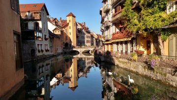 A view of Annecy old city overlooking a stone bridge and canal