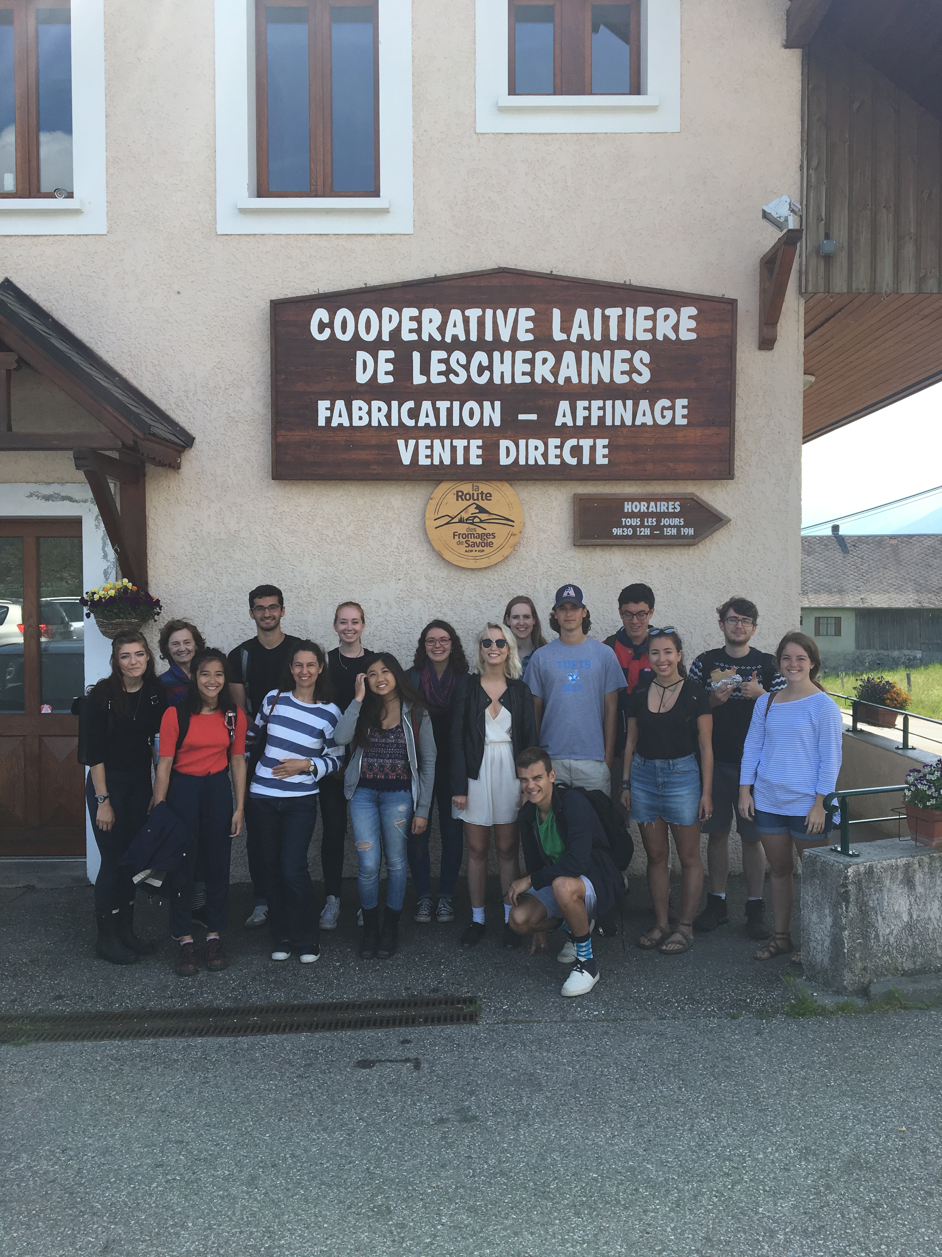 A group of students standing together in front of the Cooperative laitiere de Lescheraines