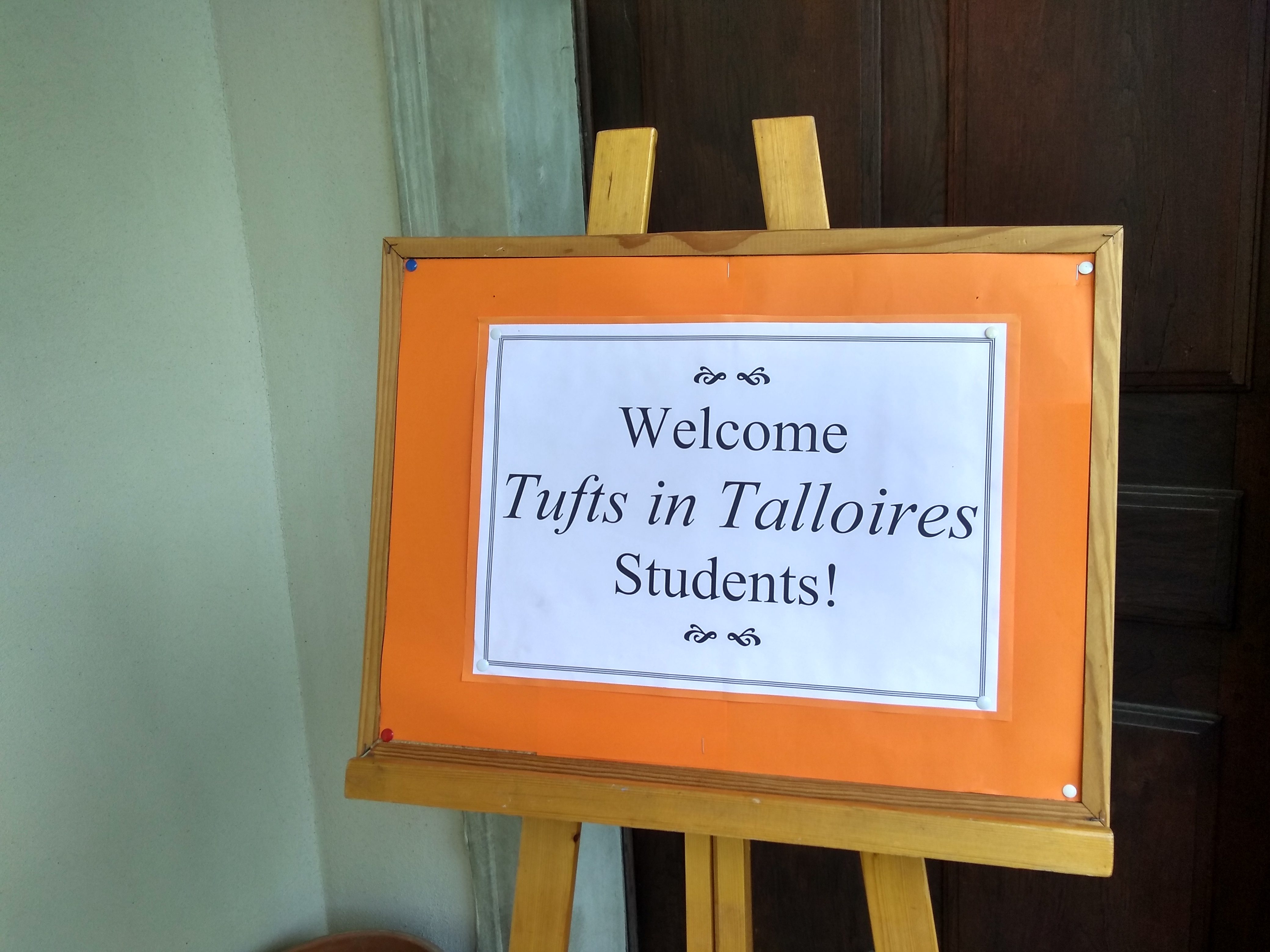 An orange bulletin board reads "Welcome Tufts in Talloires students!"