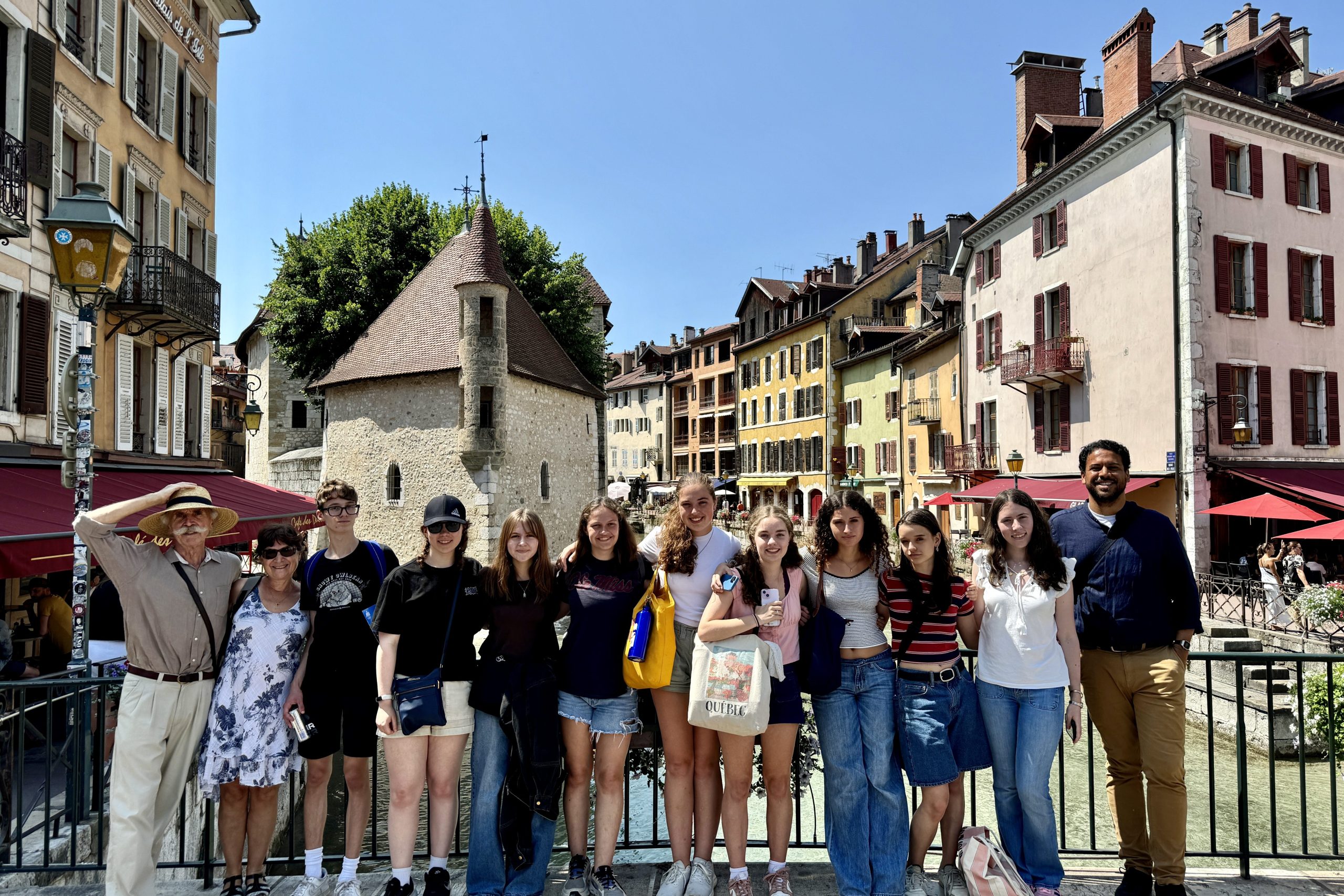 Students from Tufts Summit pose by the canals and beautiful colorful houses in Annecy, France.