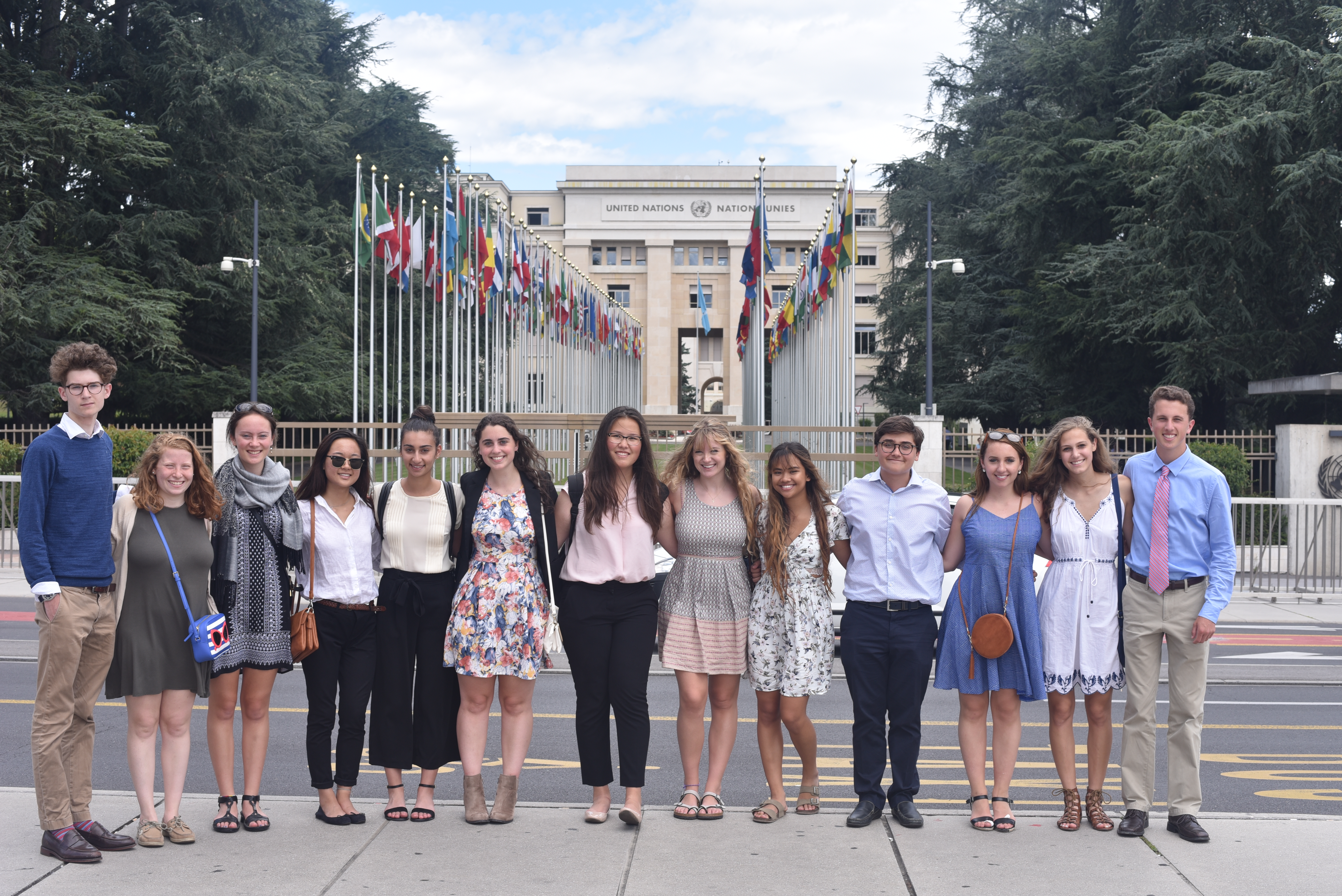 A row of students standing outside in front of the United Nations building
